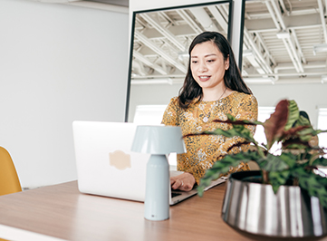 Young woman sitting at a desk on her laptop