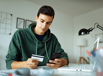 young man with credit card and phone