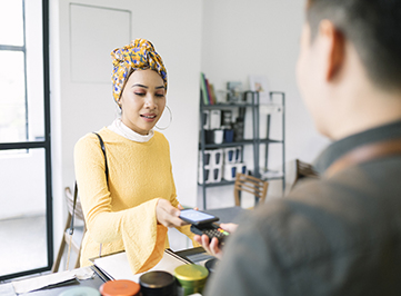 A woman paying for a purchase with her phone
