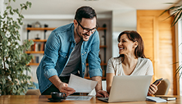 man and woman using a laptop together