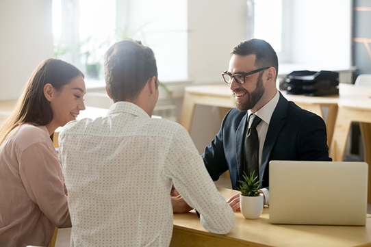 couple talking to an advisor at a desk