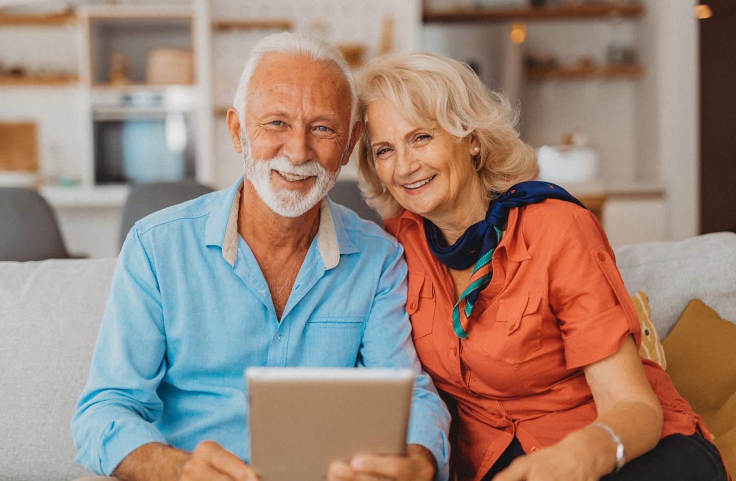 Older couple holding a tablet