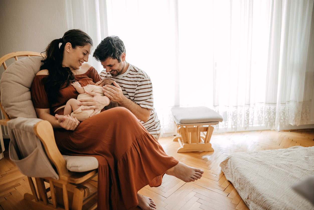 couple with baby in nursery
