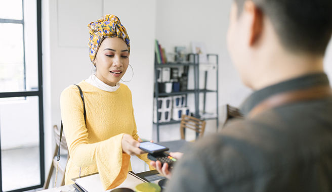 A woman paying for a purchase with her phone